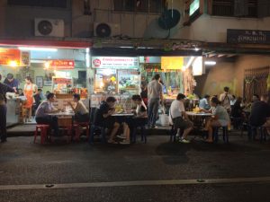 Street food patrons dine on the road at Bangkok's well-known Sukhumvit Soi 38