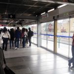 Bogotá: Example of TransMilenio station. LED displays show bus arrival times. Bus routes are organized by letter, which indicates the location/zone of a bus' final destination. Photo by Author.